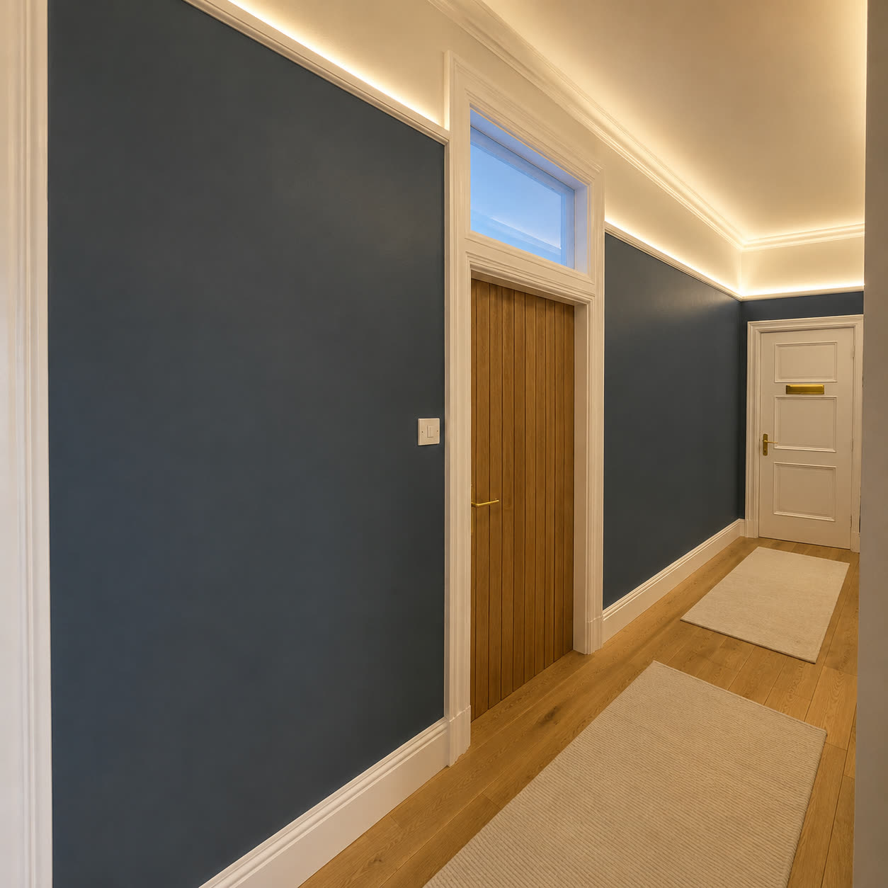 Painted hallway with a fitted oak door and white joinery